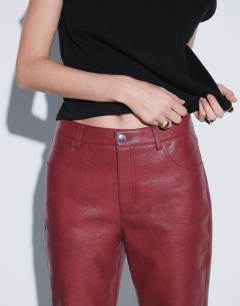 Model wearing Faux leather straight leg trousers in cherry