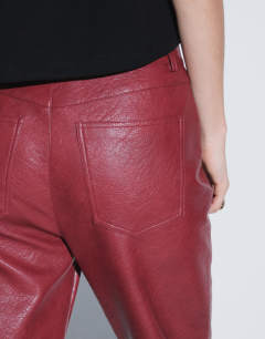 Model wearing Faux leather straight leg trousers in cherry