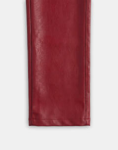 Model wearing Faux leather straight leg trousers in cherry