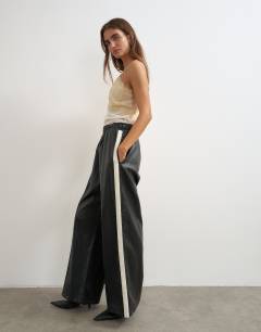 Model wearing Faux leather stripe wide leg trousers in black