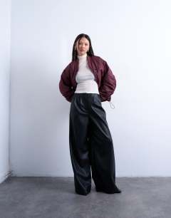 Model wearing Faux leather super wide leg trouser in black