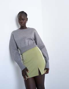 Model wearing Faux leather textured mini pelmet skirt in avocado