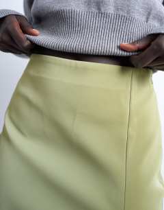Model wearing Faux leather textured mini pelmet skirt in avocado