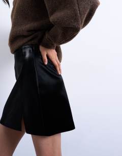 Model wearing Faux leather textured mini pelmet skirt in black