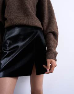 Model wearing Faux leather textured mini pelmet skirt in black