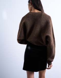 Model wearing Faux leather textured mini pelmet skirt in black