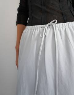 Model wearing Faux leather tie waist slouchy slim maxi skirt in light grey
