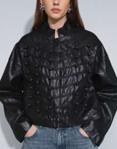 Model wearing Faux leather ultimate drummer jacket in black