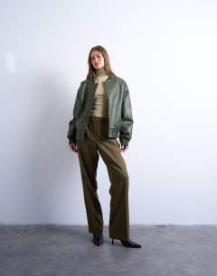 Model wearing Faux leather vintage wash oversized collarless bomber jacket in green