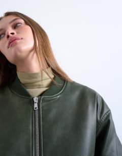 Model wearing Faux leather vintage wash oversized collarless bomber jacket in green