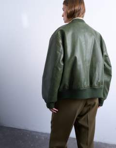 Model wearing Faux leather vintage wash oversized collarless bomber jacket in green