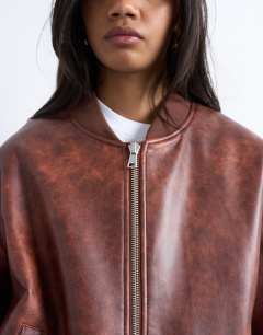 Model wearing Faux leather vintage wash oversized collarless bomber jacket in tan