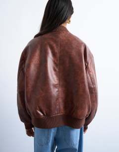 Model wearing Faux leather vintage wash oversized collarless bomber jacket in tan