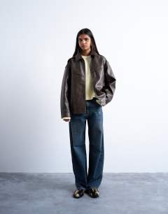 Model wearing Faux leather vintage wash seam detail zip thru bomber jacket in washed brown