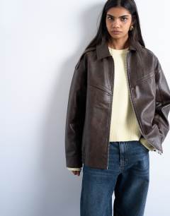 Model wearing Faux leather vintage wash seam detail zip thru oversized bomber jacket in washed brown