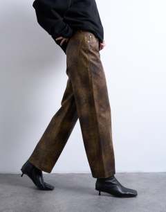 Model wearing Faux leather washed brown straight leg trouser in brown