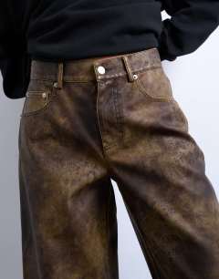 Model wearing Faux leather washed brown straight leg trouser in brown