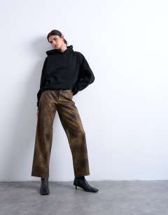 Model wearing Faux leather washed brown straight leg trouser in brown