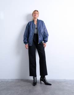 Model wearing Faux leather washed MA1 bomber jacket in denim blue