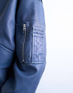 Model wearing Faux leather washed MA1 bomber jacket in denim blue