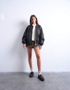 Model wearing Faux leather washed MA1 bomber jacket in washed black