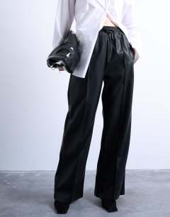 Model wearing Faux leather wide leg jogger with pinseam detail in black