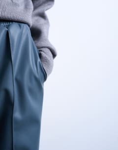 Model wearing Faux leather wide leg jogger with pinseam detail in blue