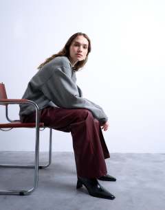 Model wearing Faux leather wide leg jogger with pinseam detail in burgundy