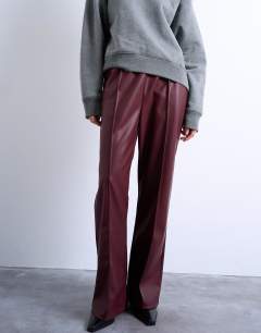 Model wearing Faux leather wide leg jogger with pinseam detail in burgundy