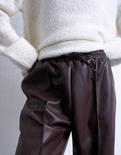 Model wearing Faux leather wide leg jogger with pinseam detail in chocolate