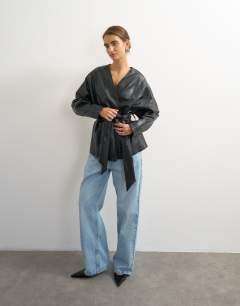 Model wearing Faux leather wrap tie detail top in black