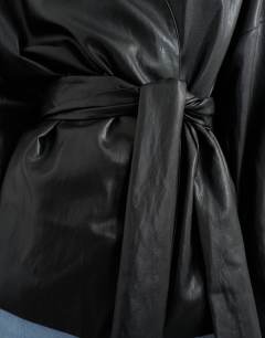 Model wearing Faux leather wrap tie detail top in black