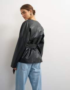 Model wearing Faux leather wrap tie detail top in black