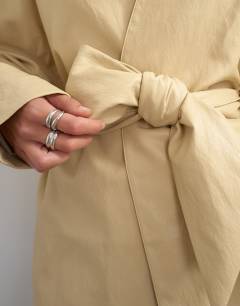 Model wearing Faux leather wrap tie detail top in buttermilk