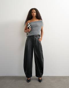Model wearing Faux leather yoke detail barrel leg in black