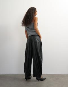 Model wearing Faux leather yoke detail barrel leg in black