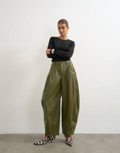 Model wearing Faux leather yoke detail barrel leg in khaki