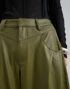 Model wearing Faux leather yoke detail barrel leg in khaki