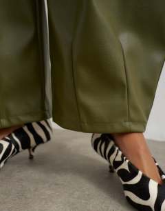 Model wearing Faux leather yoke detail barrel leg in khaki