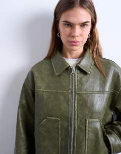 Model wearing Faux leather zip through jacket with patch pockets in washed green