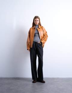 Model wearing Faux leather zip through seam detail jacket in tan