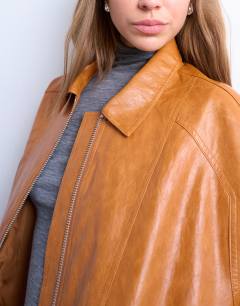 Model wearing Faux leather zip through seam detail jacket in tan