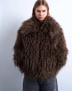 Model wearing Faux mongolian fur bomber coat in chocolate