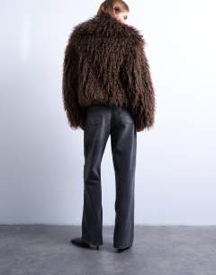 Model wearing Faux mongolian fur bomber coat in chocolate
