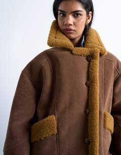 Model wearing Faux shearling oversized car coat in brown