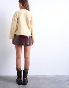 Model wearing Faux snake patent leather mini skirt in burgundy