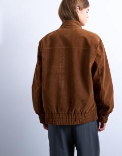 Model wearing Faux suede bomber jacket with funnel collar in tan