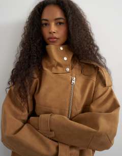 Model wearing Faux suede fold funnel biker in tan