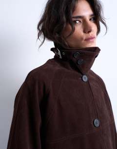 Model wearing Faux suede funnel long car coat with neck tab in brown