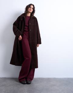 Model wearing Faux suede funnel long car coat with neck tab in brown